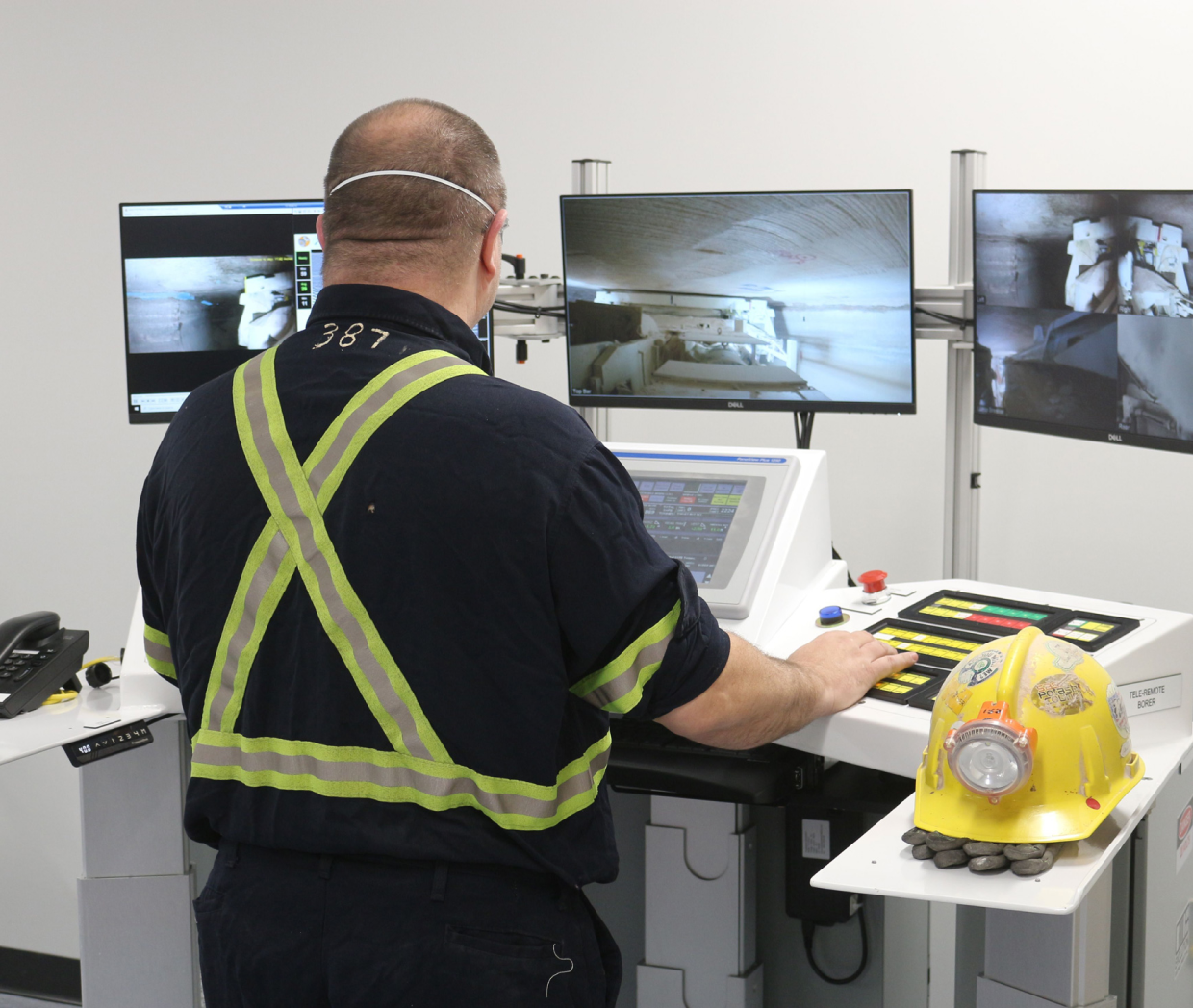 An operator standing at the control station wearing safety clothing.