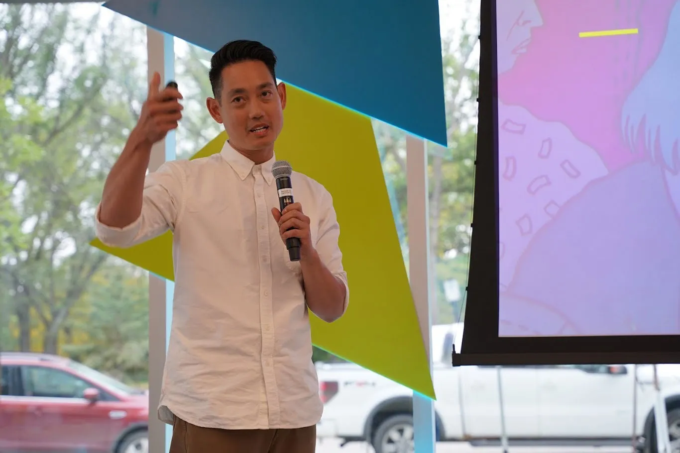 Albert Jame with a mic in hand, speaking