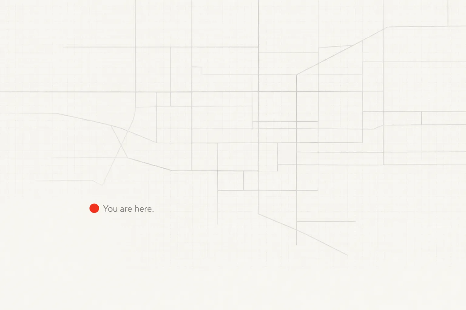 You are here within an unfinished system Minimal off-white composition with a faint, incomplete grey grid system; a small orange dot in the lower-left quadrant marks position beside the text “You are here.”