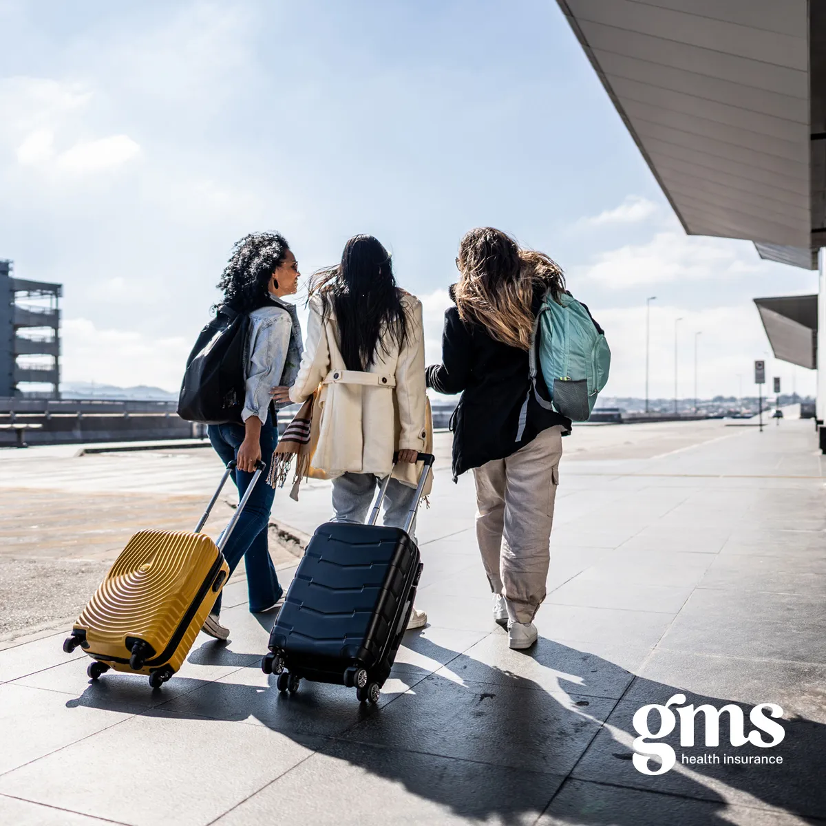 Three women at the airport with their luggage