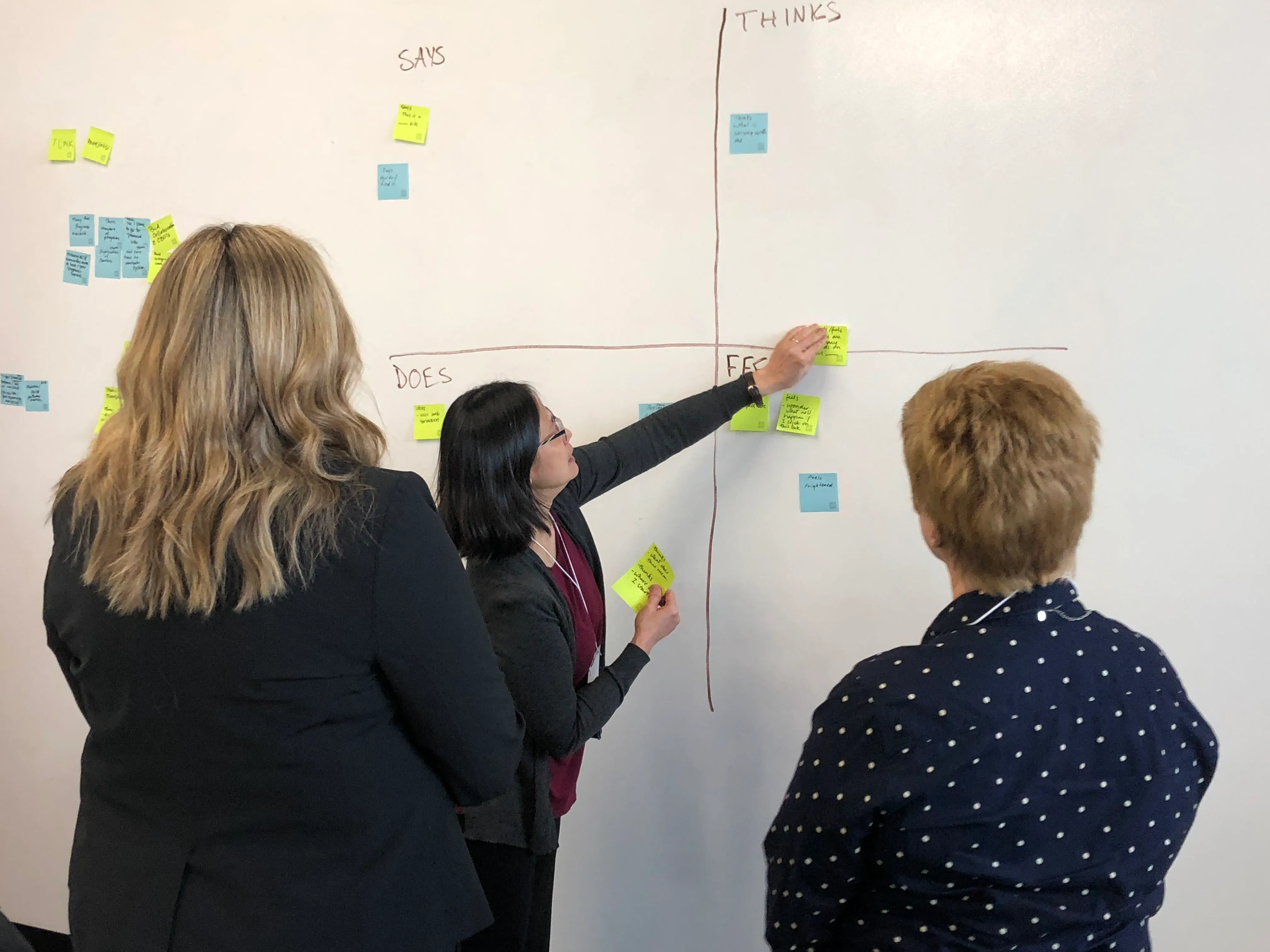 Three phones showing Moms & Kids Health Saskatchewan web pages