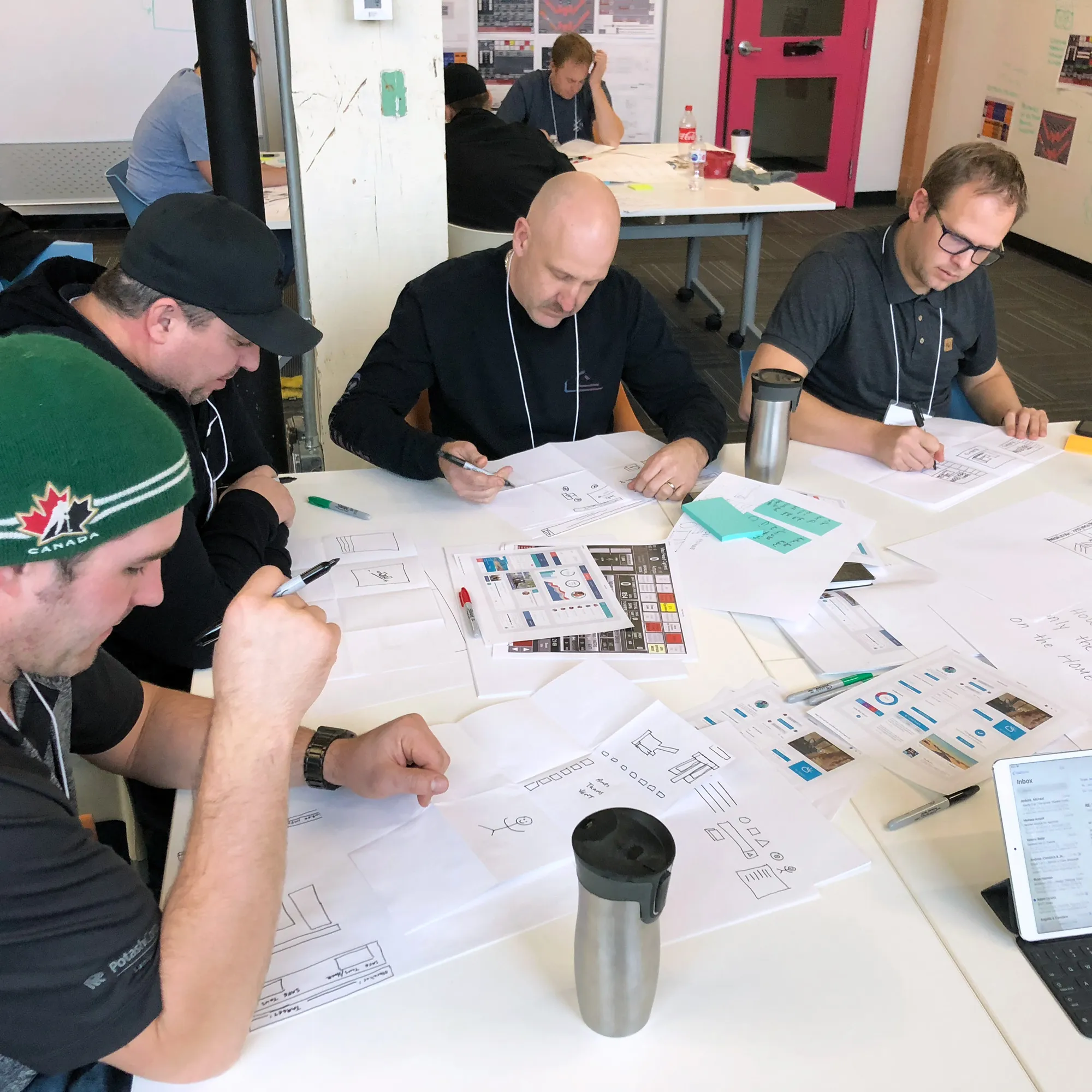 A group of men brainstorming at a table.