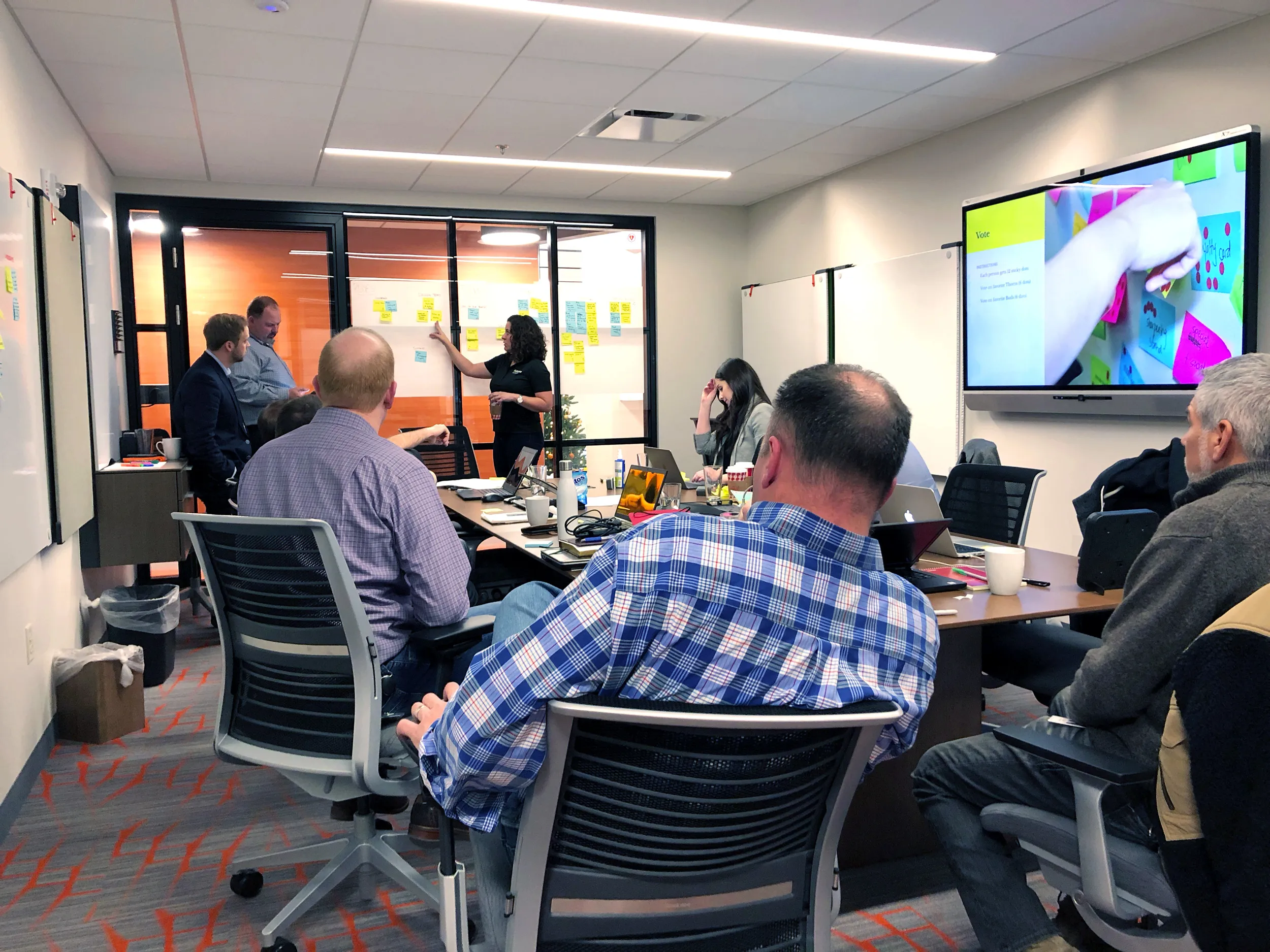 Procurement workshop meeting with team members in a conference room