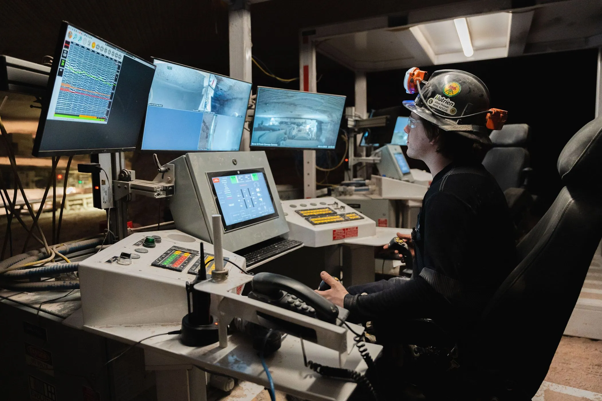 Underground tele-remote operator using joysticks while monitoring several live video feeds